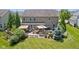 Aerial view of a spacious backyard featuring a patio, outdoor seating, grill, and lush greenery at 1294 Vista Way, Greenwood, IN 46143