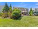 Backyard featuring an outdoor patio with dining and grilling, and lush landscaping at 1294 Vista Way, Greenwood, IN 46143