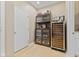 Home bar area with glass cabinets, wine cooler, and wood flooring at 1294 Vista Way, Greenwood, IN 46143