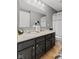 Bathroom featuring double sinks, dark cabinets, and modern fixtures at 1294 Vista Way, Greenwood, IN 46143