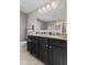 Modern bathroom featuring a double sink vanity with granite countertop and a large mirror at 1294 Vista Way, Greenwood, IN 46143