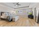 Spacious bedroom with tray ceiling, ceiling fan, and light wood floors at 1294 Vista Way, Greenwood, IN 46143