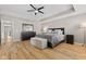 Bedroom with light wood floors, neutral walls, and tray ceiling at 1294 Vista Way, Greenwood, IN 46143