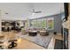Open-concept living space with hardwood floors and a cozy sectional sofa by the fireplace at 1294 Vista Way, Greenwood, IN 46143