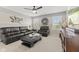 Comfortable living room boasts a sleek black leather sofa, stylish coffee table, and plenty of natural light at 1294 Vista Way, Greenwood, IN 46143
