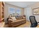 Comfortable home office featuring a loveseat and built in bookshelves at 1294 Vista Way, Greenwood, IN 46143