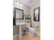 Powder room with pedestal sink, designer mirror, and sconce lighting at 1294 Vista Way, Greenwood, IN 46143