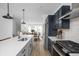 Stylish kitchen with a central island, stainless steel appliances, and sleek countertops, designed for modern living at 1315 Colere Pl, Indianapolis, IN 46203
