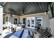 Covered patio with an outdoor seating area, ceiling fan, and television at 13613 Lake Ridge Ln, McCordsville, IN 46055