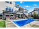 Spacious backyard view of house, pool, bar, and outdoor entertainment space at 13613 Lake Ridge Ln, McCordsville, IN 46055