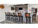 Modern bar area with custom cabinetry, granite counters, and seating at 13613 Lake Ridge Ln, McCordsville, IN 46055