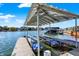 Covered boat lift offering convenience and protection for watercraft in a scenic waterfront setting at 13613 Lake Ridge Ln, McCordsville, IN 46055