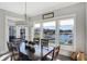Dining room with a large table and a view of the lake through large windows at 13613 Lake Ridge Ln, McCordsville, IN 46055