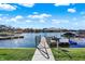 Waterfront property featuring a private dock with boat lift and picturesque lake views under a sunny sky at 13613 Lake Ridge Ln, McCordsville, IN 46055
