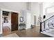 Elegant foyer featuring hardwood floors and view of the office through a rustic barn door at 13613 Lake Ridge Ln, McCordsville, IN 46055