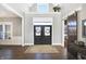 Elegant foyer featuring hardwood floors, a decorative front door, and a stylish barn door at 13613 Lake Ridge Ln, McCordsville, IN 46055