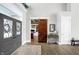 Elegant foyer with hardwood floors and decorative front door with view of the office through a barn door at 13613 Lake Ridge Ln, McCordsville, IN 46055