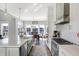 Modern kitchen with a large island, stainless appliances, and lake view dining at 13613 Lake Ridge Ln, McCordsville, IN 46055