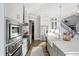 Bright kitchen features stainless steel appliances, white cabinets, and a large island with white countertops at 13613 Lake Ridge Ln, McCordsville, IN 46055