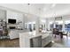 Open concept kitchen with island, stainless appliances, and views of the living room and waterfront at 13613 Lake Ridge Ln, McCordsville, IN 46055