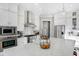 Well-lit kitchen featuring stainless steel appliances, white cabinets, and a large island with white countertops at 13613 Lake Ridge Ln, McCordsville, IN 46055