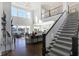 Bright living room with a staircase and lake views at 13613 Lake Ridge Ln, McCordsville, IN 46055