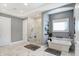 Bright main bathroom with marble flooring, large shower, and stand alone tub at 13613 Lake Ridge Ln, McCordsville, IN 46055