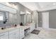 Bright main bathroom with double vanity sinks, makeup vanity, and marble flooring at 13613 Lake Ridge Ln, McCordsville, IN 46055