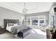 This main bedroom features a tray ceiling, waterfront views, and access to a private balcony at 13613 Lake Ridge Ln, McCordsville, IN 46055