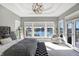 This main bedroom features a tray ceiling, waterfront views, and a sitting area at 13613 Lake Ridge Ln, McCordsville, IN 46055