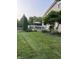 Well-maintained backyard with a manicured lawn, a white deck, and beautiful landscaping at 1378 Runningbrook Dr, Avon, IN 46123