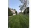 Large backyard with a meticulously maintained lawn, a white deck, and privacy fence at 1378 Runningbrook Dr, Avon, IN 46123