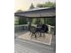Relaxing outdoor deck with a table and chairs, covered by a gazebo on an outdoor carpet at 1378 Runningbrook Dr, Avon, IN 46123