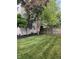 Spacious backyard with lush green grass, mulch beds, and a wooden fence at 1378 Runningbrook Dr, Avon, IN 46123