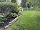 Well-maintained backyard with a playset, fenced perimeter, and mature landscaping at 1378 Runningbrook Dr, Avon, IN 46123