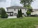 Extensive backyard featuring a manicured lawn, deck area with pergola, and privacy landscaping at 1378 Runningbrook Dr, Avon, IN 46123