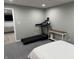 Finished basement featuring gray walls, a treadmill, a white table, and carpet at 1378 Runningbrook Dr, Avon, IN 46123