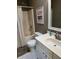 Well-lit bathroom features a shower with a curtain, a modern toilet, and a white vanity with sink at 1378 Runningbrook Dr, Avon, IN 46123