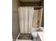 Neutral bathroom features a shower with a curtain, a modern toilet, and a dark accent rug at 1378 Runningbrook Dr, Avon, IN 46123