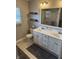 A well-lit bathroom features a double sink vanity, a large mirror, and a glass-enclosed shower stall at 1378 Runningbrook Dr, Avon, IN 46123