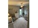 Cozy Bedroom featuring a comfortable rocking chair, a white crib and dresser, books, and a bright window view at 1378 Runningbrook Dr, Avon, IN 46123