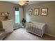 Bright Bedroom features neutral walls, a white crib and dresser, animal artwork and natural light from the window at 1378 Runningbrook Dr, Avon, IN 46123