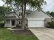 Beautifully landscaped front yard with a well-manicured lawn and an attached two-car garage at 1378 Runningbrook Dr, Avon, IN 46123