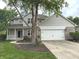 Two story home with attached garage and manicured front lawn and landscaping at 1378 Runningbrook Dr, Avon, IN 46123