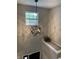 Hallway featuring gray walls, a modern light fixture, and a window at 1378 Runningbrook Dr, Avon, IN 46123