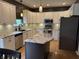 Open-concept kitchen boasts granite countertops, white cabinets, and stainless steel appliances at 1378 Runningbrook Dr, Avon, IN 46123