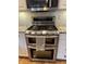 Close-up of a stainless steel range with double ovens and granite countertops at 1378 Runningbrook Dr, Avon, IN 46123