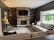 Cozy living room featuring a stone fireplace, built-in shelves, and comfortable seating at 1378 Runningbrook Dr, Avon, IN 46123