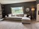 Comfortable living room featuring neutral-toned sectional sofa and natural light from the window at 1378 Runningbrook Dr, Avon, IN 46123