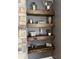Stylishly decorated wooden shelves next to a stone fireplace, adding rustic charm to the room at 1378 Runningbrook Dr, Avon, IN 46123